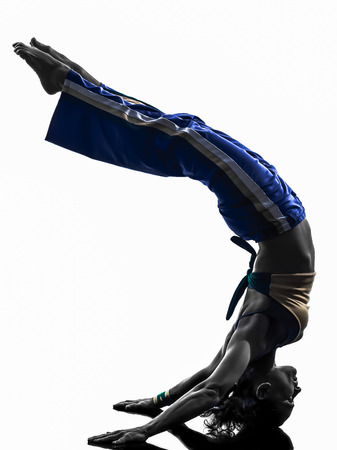 one  woman capoeira dancer dancing in silhouette studio isolated on white backgroundの写真素材