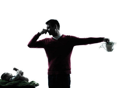 parents with smeely baby diaper in silhouettes on white backgroundの写真素材