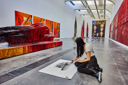 Beijing , China - September 23, 2014 : student painting inside the UCCA in the  798 Art District zone aera in Beijing Chinaのeditorial素材