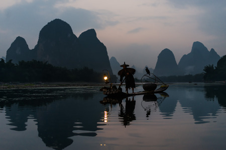 Yangshuo , China - September 29 , 2014 : fisherman fishing  with cormorant Li river, between Guilin and Yangshuo in Guangxi province  Chinaのeditorial素材