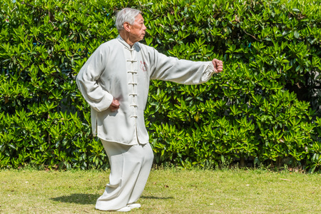 Shanghai, China - April 7, 2013: one old man exercising kung fu in fuxing park at the city of Shanghai in China on april 7th, 2013のeditorial素材