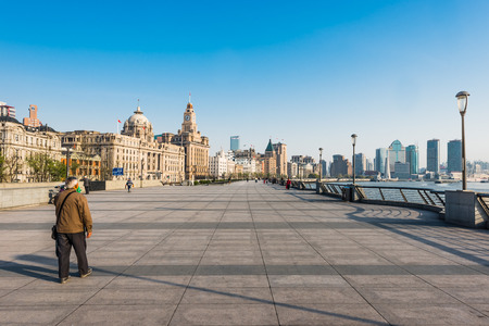 Shanghai, China - April 7, 2013:people working on the bund waterfront hangpu river at the city of...