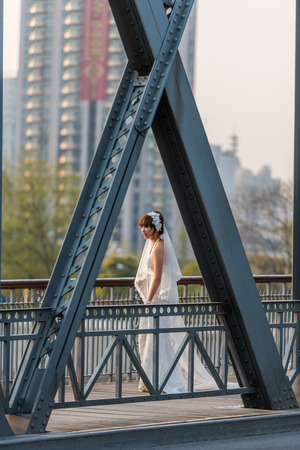Shanghai, China - April 10, 2013: young wedding bride on The Waibaidu Bridge at the city of Shanghai in China on april 10th, 2013のeditorial素材