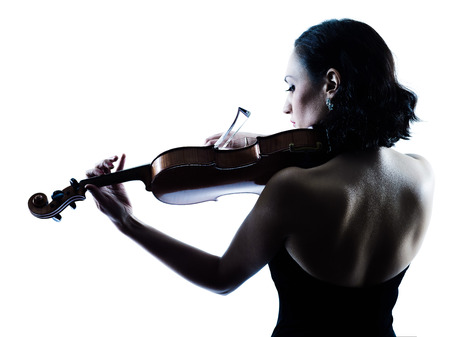 one caucasian Violinist woman player playing violon studio slihouette isolated in white backgroundの写真素材