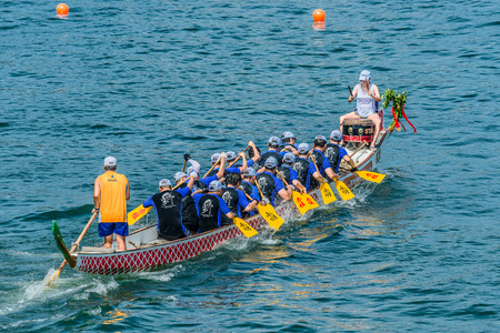 Hong Kong, China- June 2 , 2014: People racing the Dragon boats festival race in Stanley beachのeditorial素材