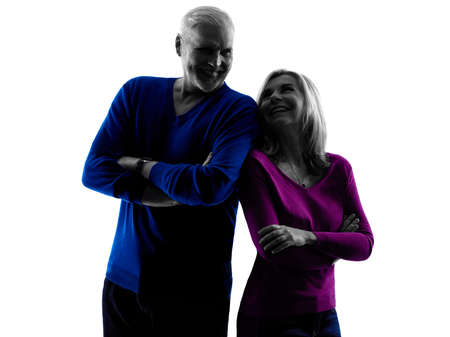 one caucasian couple senior standing  silhouette  in silhouette studio isolated on white backgroundの写真素材
