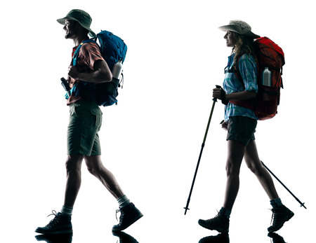 one caucasian couple trekker trekking walking nature in silhouette isolated on white backgroundの写真素材