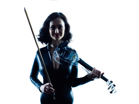 one caucasian Violinist woman player playing violon studio slihouette isolated in white backgroundの写真素材