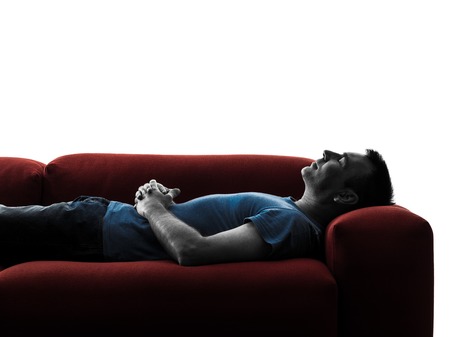 one caucasian man sofa couch sleeping in silhouette isolated on white backgroundの写真素材