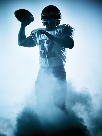 one american football player portrait in silhouette shadow on white backgroundの写真素材