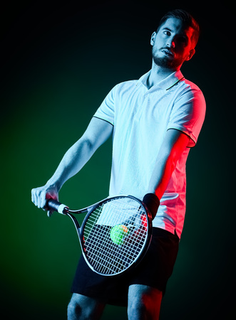 one caucasian tennis player man studio isolated on black backgroundの写真素材
