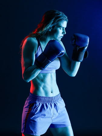 one caucasian woman boxer boxing isolated on black backgroundの写真素材