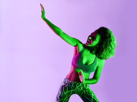 one caucasian woman dancer dancing fitness exercises isolated on colorful backgroundの写真素材