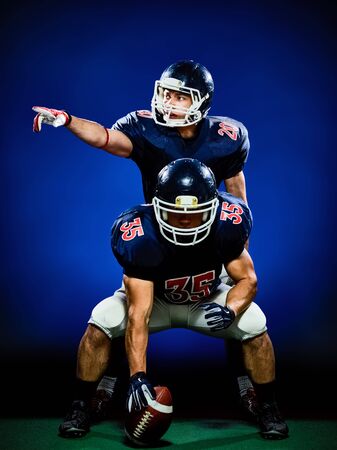 two american football players men isolated on colorful black backgroundの写真素材