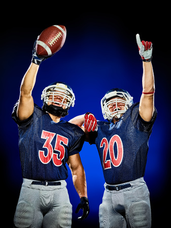 two american football players men isolated on colorful black backgroundの写真素材