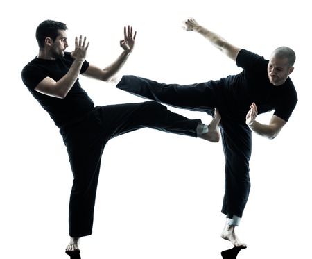 two caucasian men krav maga fighters fighting isolated silhouette on white backgroundの写真素材
