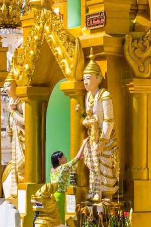 YANGON, MYANMAR - DECEMBER 16, 2016 : woman praying at Shwedagon Pagoda Yangon (Rangoon) in Myanmar (Burma)のeditorial素材