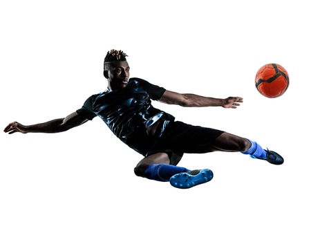 one african soccer player man playing in studio isolated on white backgroundの写真素材