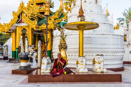 YANGON, MYANMAR - DECEMBER 16, 2016 : monks praying at Shwedagon Pagoda Yangon (Rangoon) in Myanmar (Burma)のeditorial素材