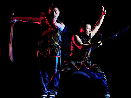 whushu chinese boxing kung fu Hung Gar fighter isolated man isolated on black background with speed...