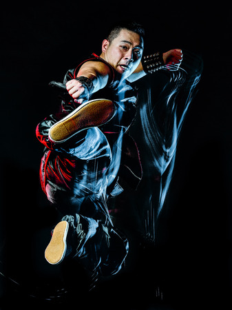 whushu chinese boxing kung fu Hung Gar fighter isolated man isolated on black background with speed light painting effect motion blurの写真素材