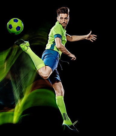 one caucasian soccer player man isolated on black background with light painting speed effectの写真素材