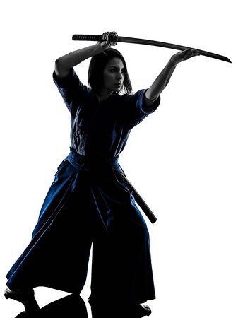 one caucasian woman practicing laido Katori Shinto ryu shadow silhouette isolated on white backgroundの写真素材
