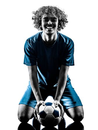 one mixed race young teenager soccer player man playing in silhouette isolated on white backgroundの写真素材