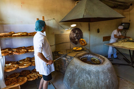 Ninotsminda , Georgia - August 15, 2019 : Puri Tandoor oven bread making in a bakery of Ninotsminda Samtskhe Javakheti region Georgia eastern Europeのeditorial素材