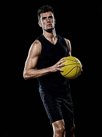 one caucasian young basketball player man in studio isolated on black backgroundの写真素材