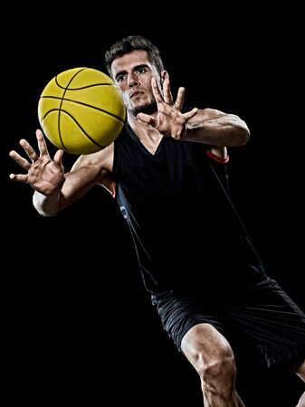 one caucasian young basketball player man in studio isolated on black backgroundの写真素材