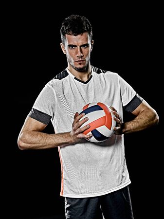 one caucasian young volley ball player man in studio isolated on black backgroundの写真素材