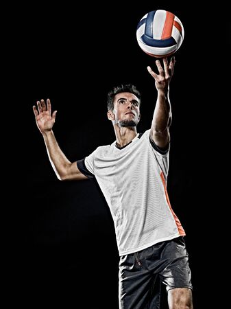 one caucasian young volley ball player man in studio isolated on black backgroundの写真素材