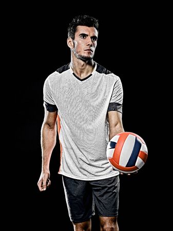 one caucasian young volley ball player man in studio isolated on black backgroundの写真素材