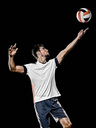 one caucasian young volley ball player man in studio isolated on black backgroundの写真素材