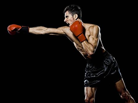 one caucasian young man boxer boxing profile side view in studio isolated on black backgroundの写真素材