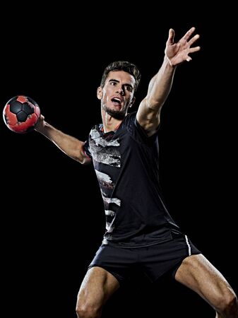 one caucasian young handball player man in studio isolated on black backgroundの写真素材