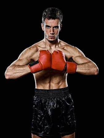 one caucasian young player man boxer boxing portrait waist up in studio isolated on black backgroundの写真素材