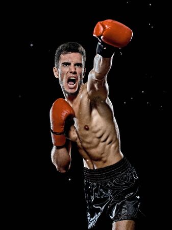 one caucasian young player man boxer boxing portrait waist up in studio isolated on black backgroundの写真素材