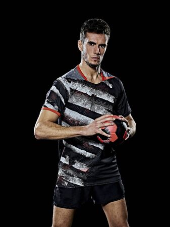 one caucasian young handball player man in studio isolated on black backgroundの写真素材