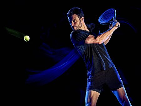 Paddle tennis player man light painting isolated black backgroundの写真素材