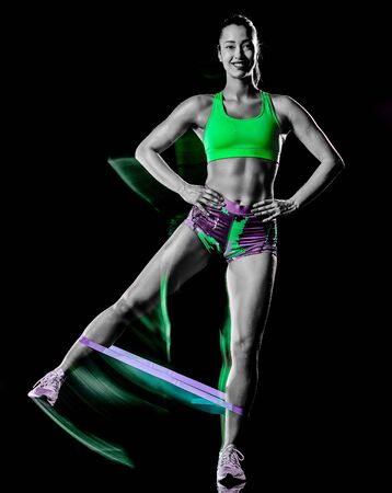 woman exercising fitness exercises isolated black background lightpainting effectの写真素材