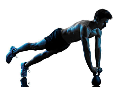 man fitness Kettle Bell exercise shadow isolated white background silhouetteの写真素材
