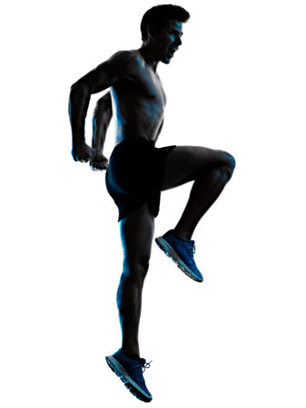 young man fitness exercise exercIsing shadow isolated white background silhouetteの写真素材