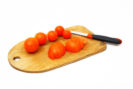 tomatoes cut into the old boardの写真素材