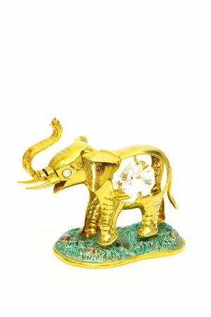 Jewellery elephant figurine crystals of gold on a white backgroundの写真素材