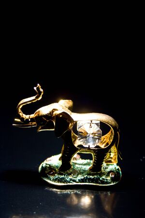 Jewellery gold statuette elephant crystals on a black backgroundの写真素材