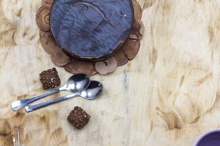 Sliced tasty chocolate cake on wooden table backgroundの写真素材