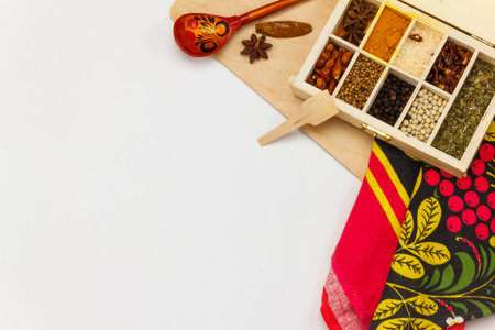 Assortment of spices in wooden box on whie background