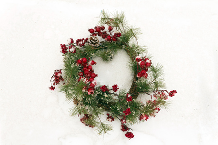 Christmas wreath branches on snow in winterの写真素材